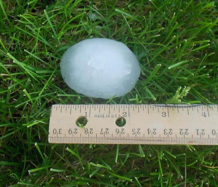 Two inch hail ball in Alpharetta grass.