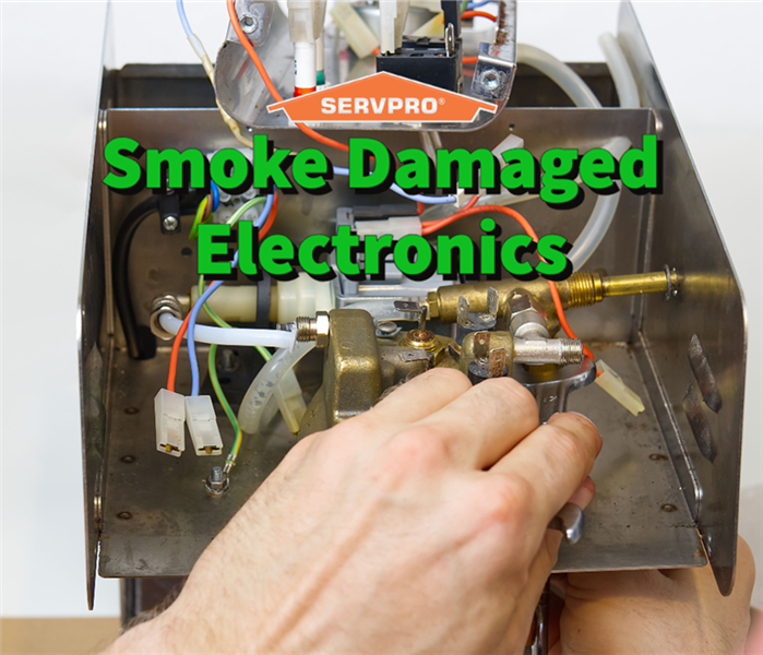 A SERVPRO professional cleaning soot out of electronics